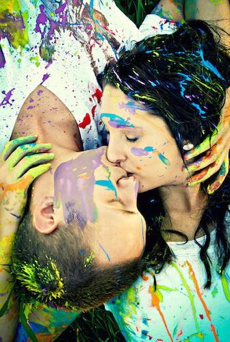 Paint-covered lovers kissing