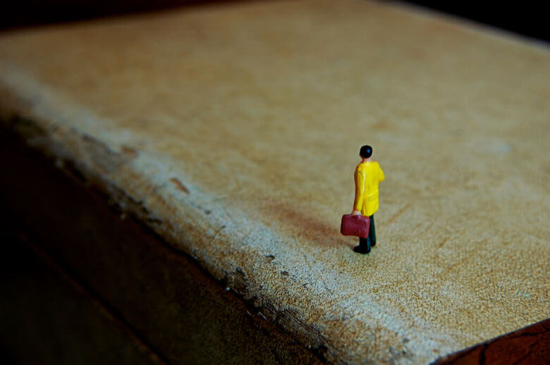 Small toy figure of man with suitcase