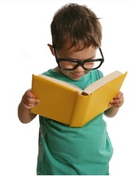Young boy with thick glasses reading