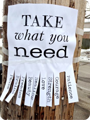 A message on a pole saying 'Take what you need'. You can tear off pieces of paper with words like Patience and Courage