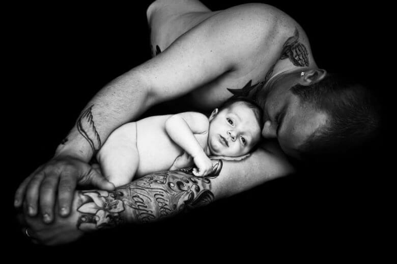 tattooed man with baby