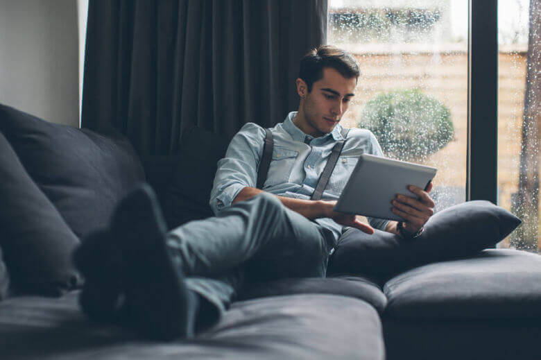 Man on a tablet in a long distance relationship