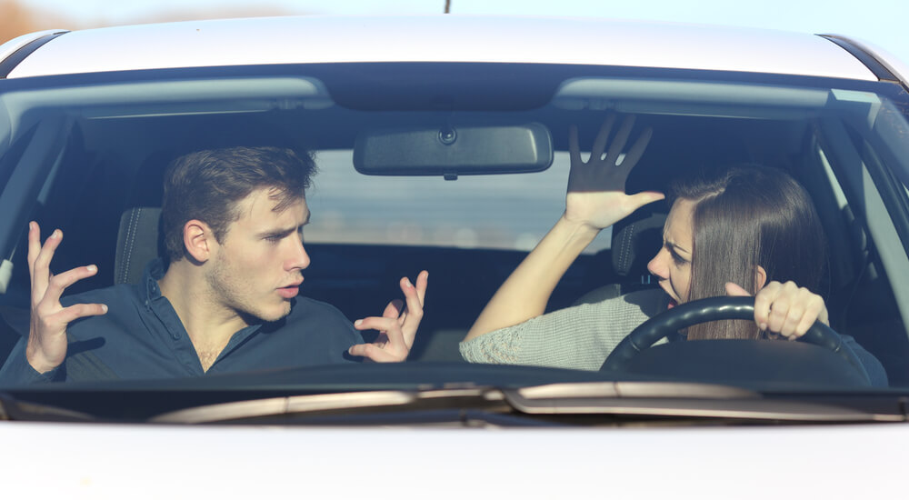 Couple arguing while she is driving a car in a dangerous situation