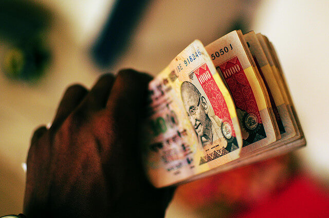 Man holding rupees