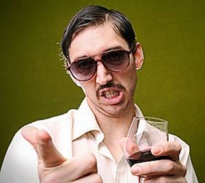 Creepy man holding a glass of wine