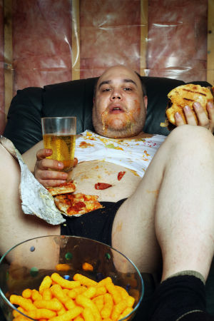 fat-man-binging-on-couch-300x450.jpg