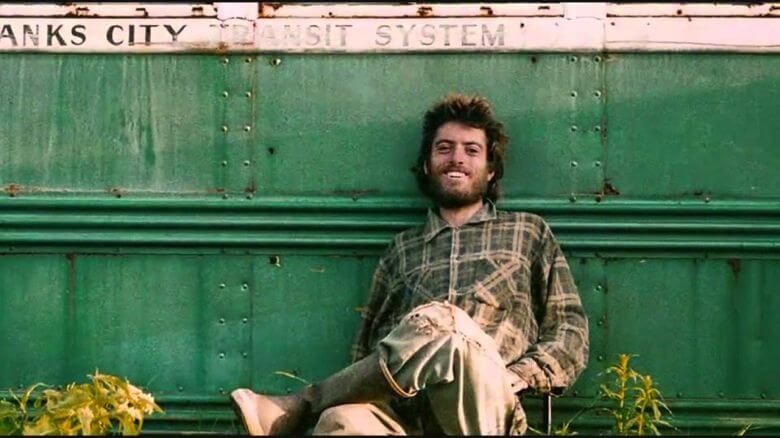 A photo of the real-life Chris McCandless in front of the bus in which he would eventually die.