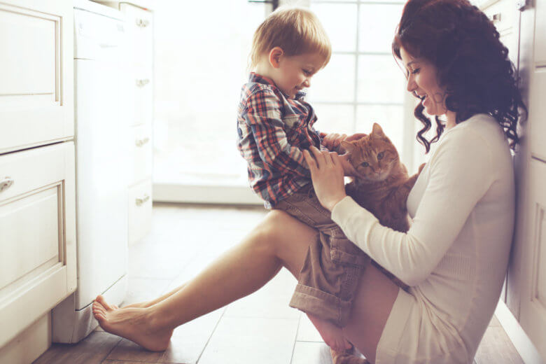 How to grow up and be more mature: Mother and child playing with cat