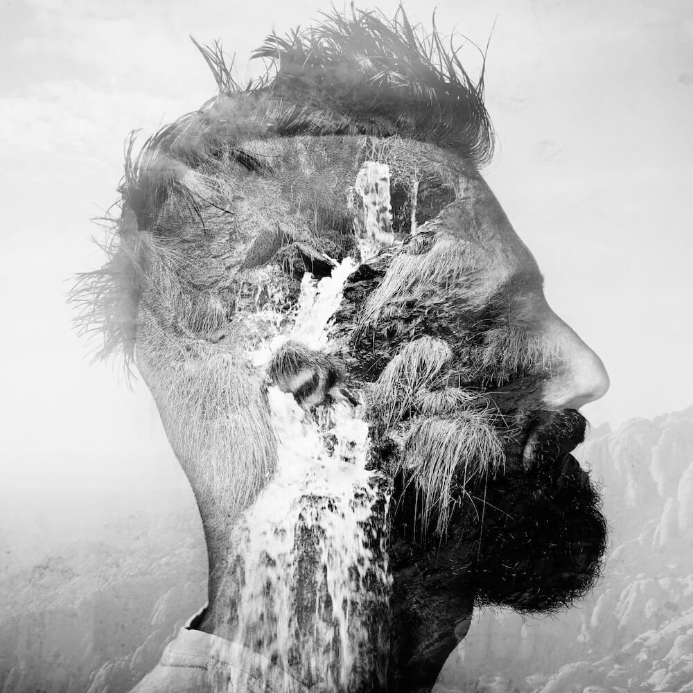 Self-awareness BW double exposure portrait of a man with mohawk and a mountain