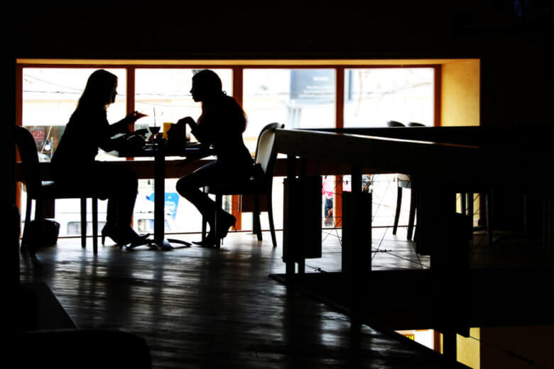 Two women having a conversation in a cafe