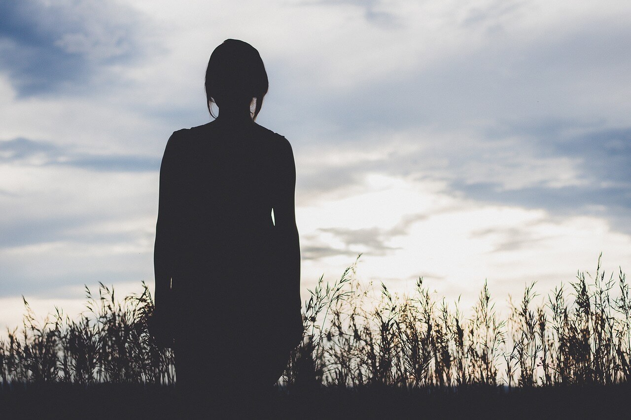 Silhouette of woman in field